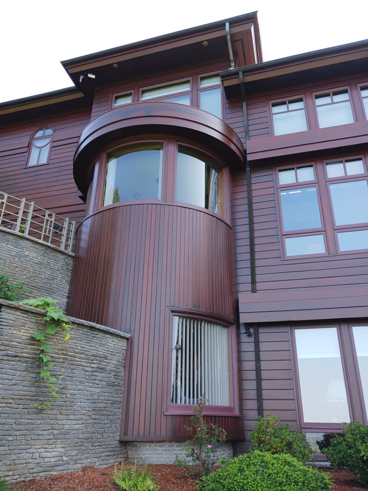 Exterior House Dark Reddish Brown Siding Curved Window Stone Wall — Frank Leonard Painting LLC